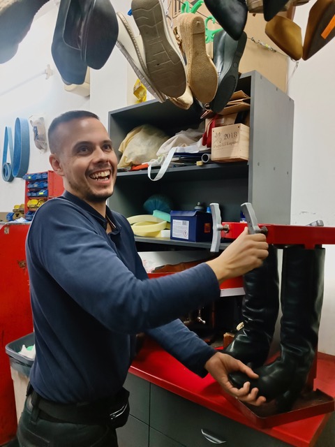 Jaime fixing a pair of boots with a smile. Photo © Karethe Linaae
